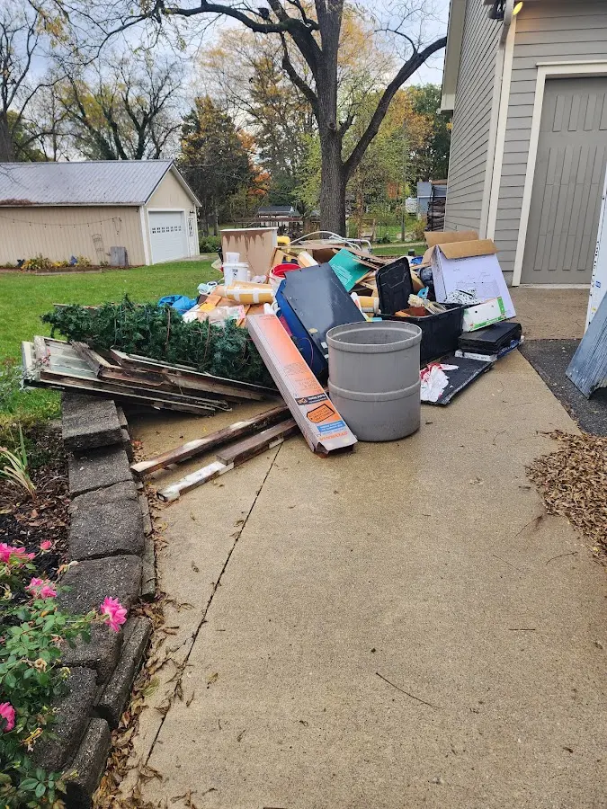 Dumpster being loaded with debris for 30 Yard Dumpster Rental in Wolcott